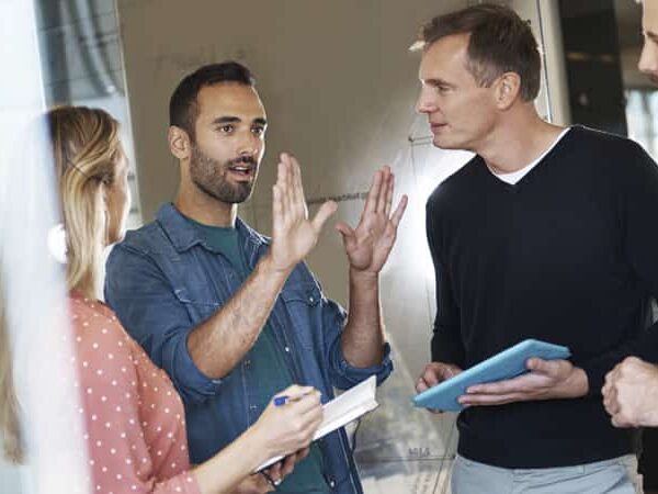 man explaining idea to colleagues