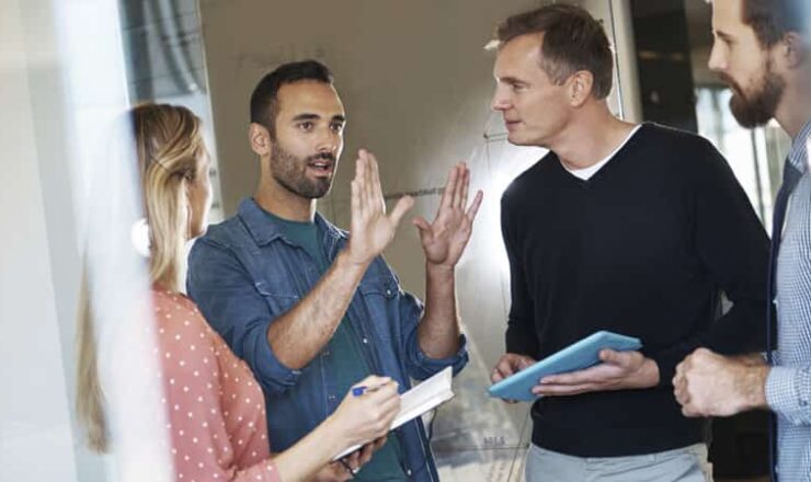 man explaining idea to colleagues