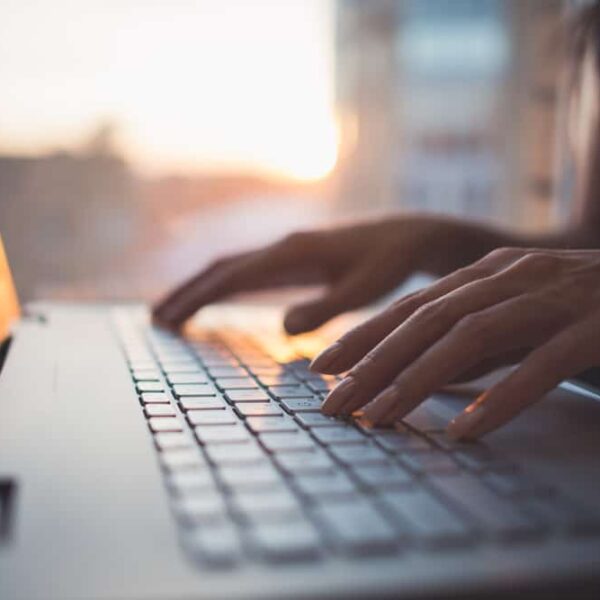 close up of person typing on a computer